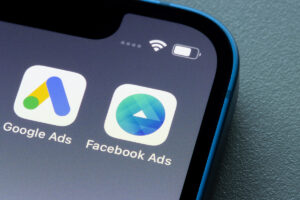 Mobile phone screen showing apps for Google Ads and Facebook Ads